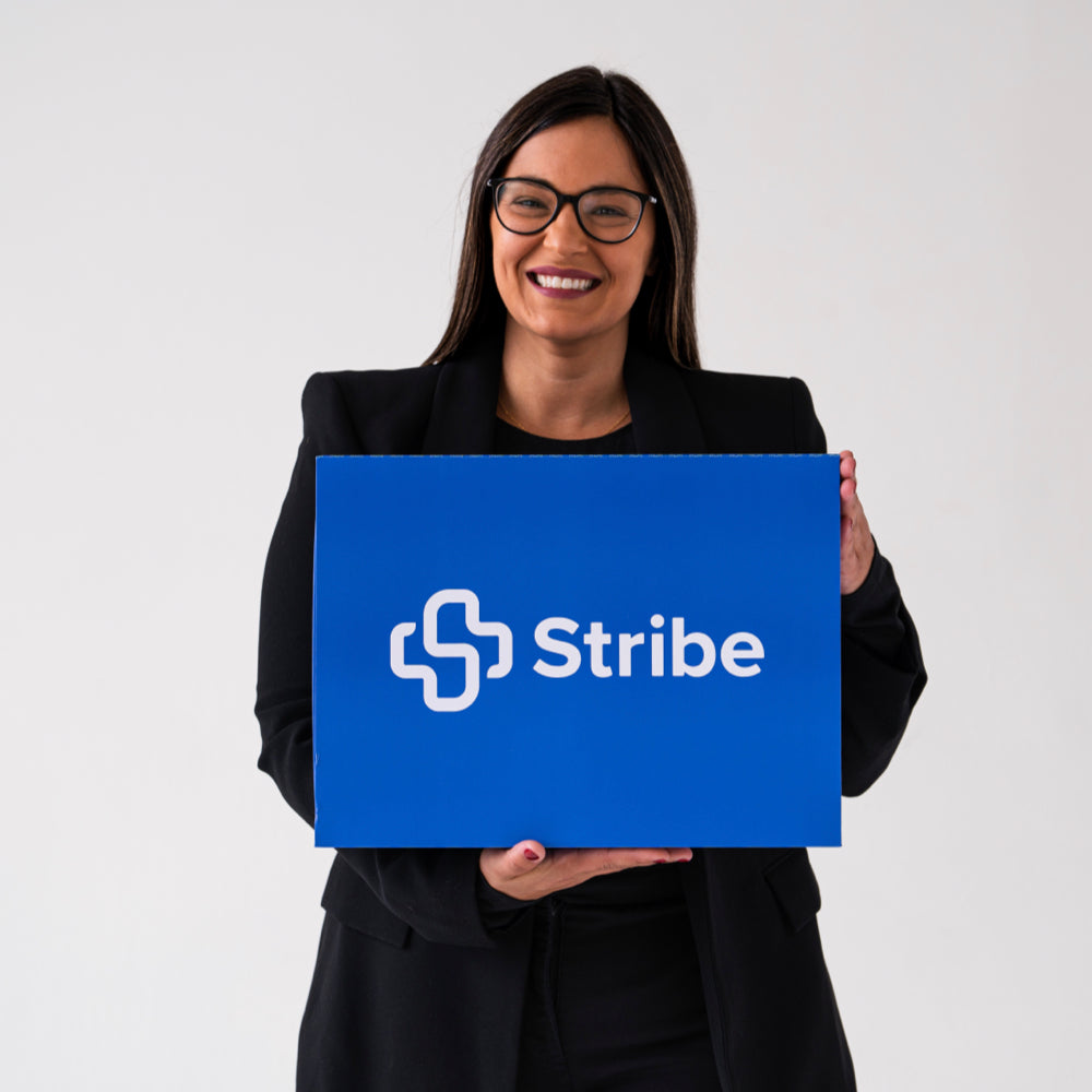 Dr. Andi-Jean Miro holding The Box, the Stribe dental photography kit