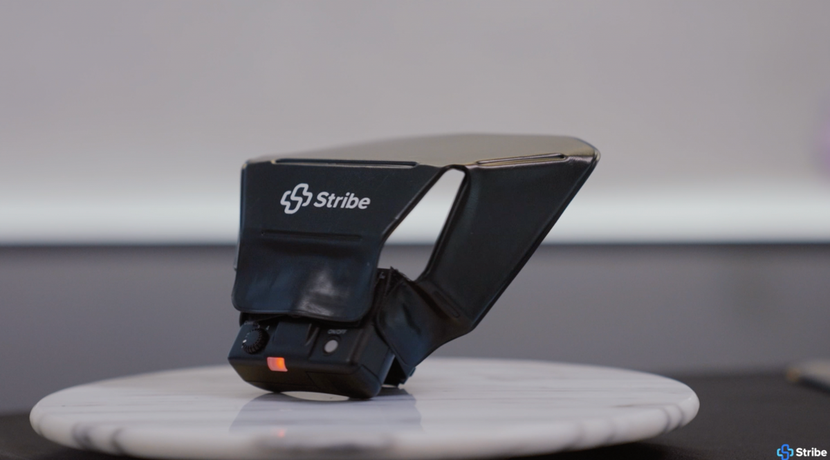 Stribe Bouncer flash diffuser shown on a marble stand