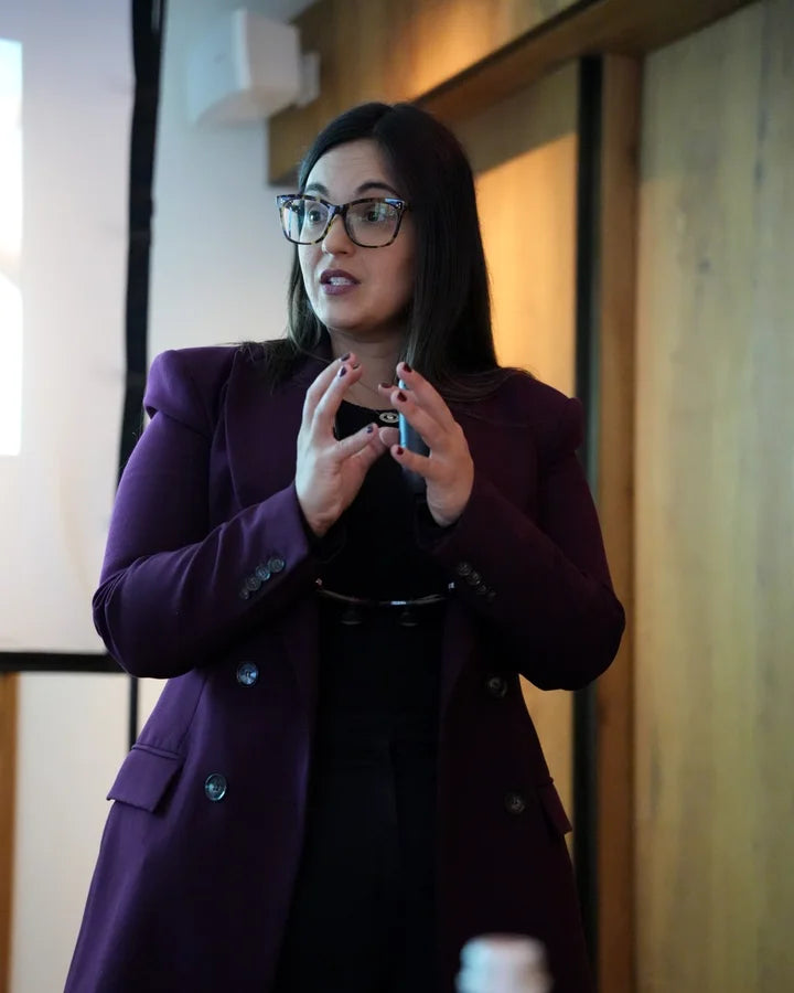 Dr. Andi-Jean Miro explaining her cosmetic dentistry protocol to a class, with stone models on the table