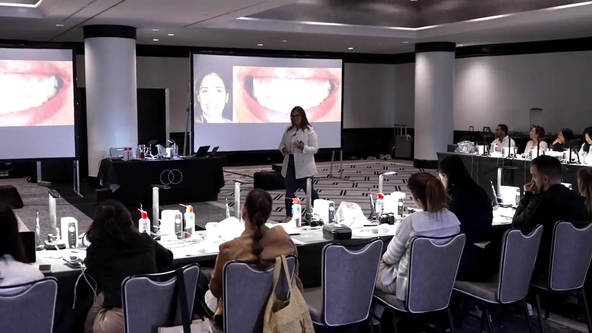 Dr. Andi-Jean Miro presenting a smile design case to dentists at a Stribe Art of Ceramic course